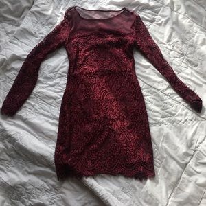A formal long sleeve maroon dress